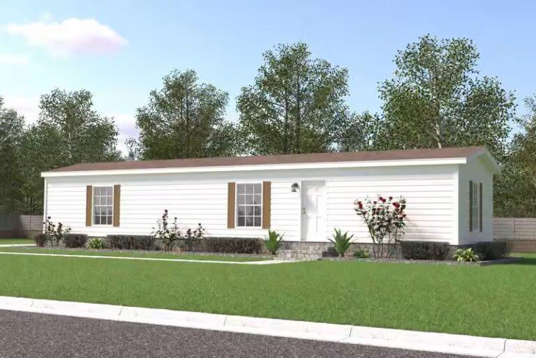 White single-wide mobile home with brown roof, brown shutters, and landscaped lawn beneath trees.